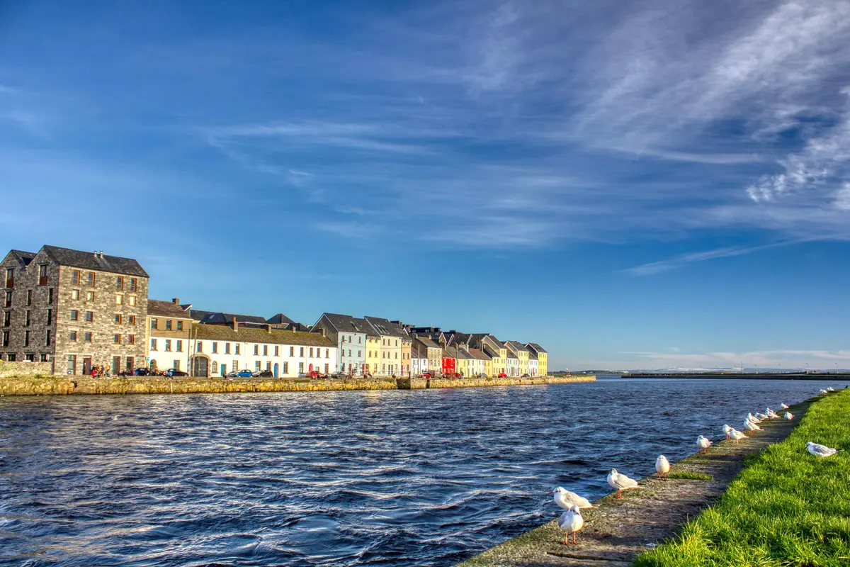 Colourful houses on the Long Walk beside Galway Bay