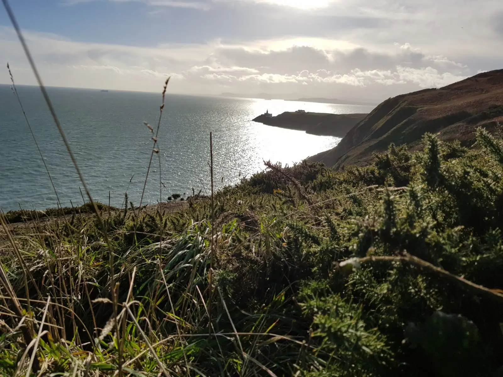 The coast path around Howth Head with the Baily lighthouse on the headland below