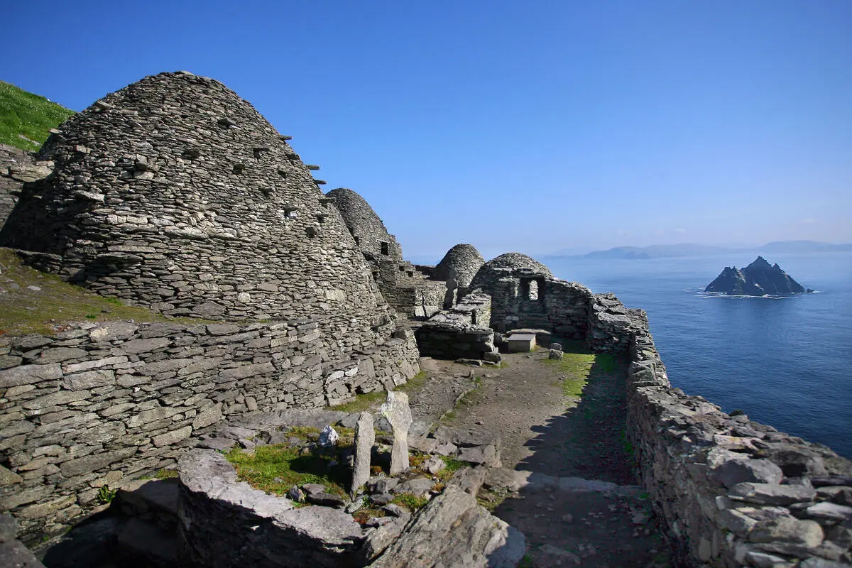 Beehive huts on Skellig Michael with Little Skellig out in the Atlantic beyond
